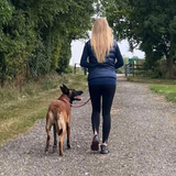 Trainer helping a dog learn to walk nicely on a lead